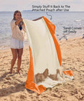Person holding Sandproof And Waterproof Beach Blanket 7x7 Ft Extra Large Mat With Stakes showing sand easily shakes off.
