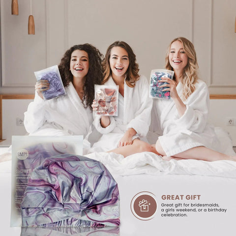 Three women in robes smiling, holding packs, with Reusable Waterproof Shower Cap For Women with Nonslip Silicone Forehead Strip visible in front.