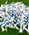 Pile of 3 1/4 Inch White With Blue Stripes Plastic Golf Tees Bulk Pack Of 100 High Visibility Durable Tees On Grass