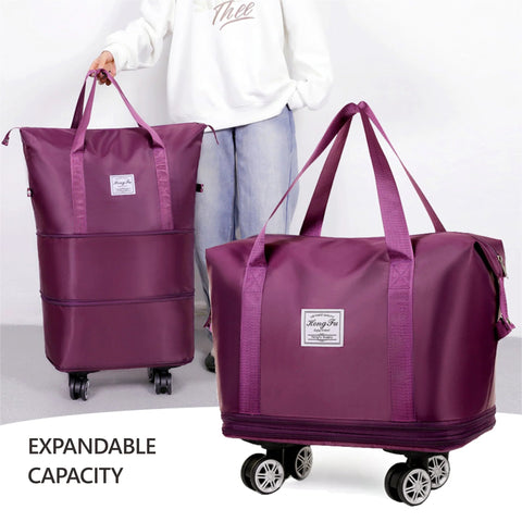 Two purple expandable foldable duffel bags with wheels; large carry-on luggage.