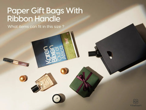 Paper gift bags with ribbon handle next to a book, lipstick, perfume, and small gift, promoting versatility and size inquiry.