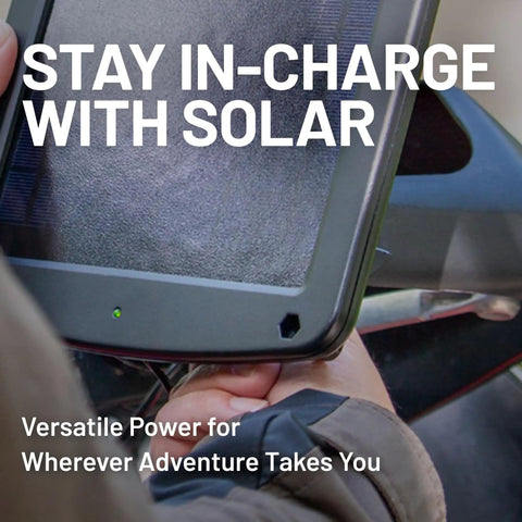 Person holding Five Watt Solar Panel 12V Battery Charger with Charge Controller IP67 weatherproof for motorcycles and cars.
