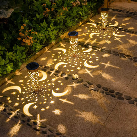Moon Star Solar Garden Stake Lights Outdoor Waterproof Copper Finish casting patterns on patio pathway at night