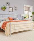 Built Tough Full Size Metal Bed Frame With Classic Headboard And Footboard In Crisp White set in a cozy bedroom with plants and decor.