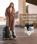 Traveler with Samsonite hard shell carry-on luggage featuring oversized 360-degree dual spinner wheels for easy maneuverability.