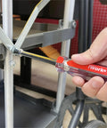 Close-up of Color Coded SAE Nut Driver Set, 7-Piece with 1/2, 7/16, 3/8, 11/32, 5/16, 1/4, 3/16 inch sizes in use on metal frame.