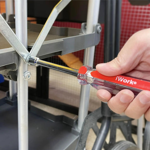 Close-up of Color Coded SAE Nut Driver Set, 7-Piece with 1/2, 7/16, 3/8, 11/32, 5/16, 1/4, 3/16 inch sizes in use on metal frame.