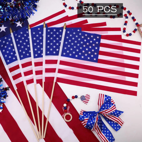 Five USA stick flags with wooden poles and spear tips, part of 50 Pack USA Stick Flags 12 By 18 Inch Small Flags With Wooden Poles.
