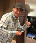 Man using Quick And Easy Frozen Water Line Defrost Tool For Refrigerator Water Dispenser Unfreeze Your Line At Home Without A Technician No Tools Needed DIY Friendly.