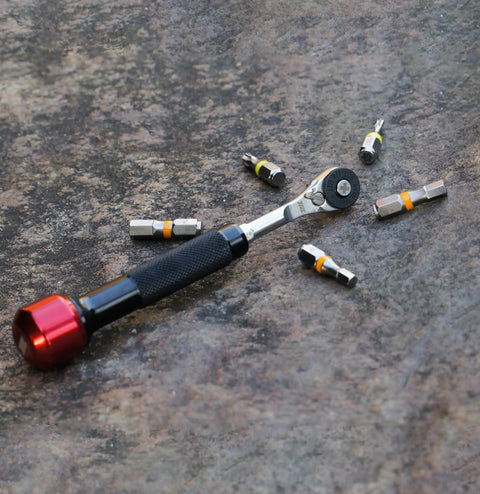 Go To One Quarter Inch Hex End EDC Ratchet Wrench For Multitools With Hex Bit Adapters Stainless Steel Build on stone surface