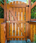 Wooden gate with 14 Pack 4 Inch T Hinge Heavy Duty Shed Door Hinges Gate Strap Black Tee Hinge For Wooden Fences installed on the side.