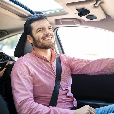 Man driving with Two Pack Car Sunglasses Clips For Sun Visor Eyeglasses Holder Mount Keeps Sunglasses Secure And Neat in black visible on visor