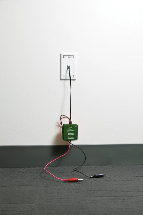 Wire Tracer Kit With Tone Generator For Cable Locator shown plugged into a wall with cables and alligator clips attached