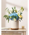 360 Degree Rotating Extra Large Ceramic Utensil Holder for Countertop With Rotatable Wooden Base Deep Capacity Kitchen Utensil Crocks Arctic White Farmhouse Decor displaying a floral arrangement on a wooden countertop.