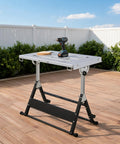 Rock Solid Folding Welding Table With Adjustable Height And Quick Tilt Settings Portable Slotted Steel Workbench on outdoor patio.