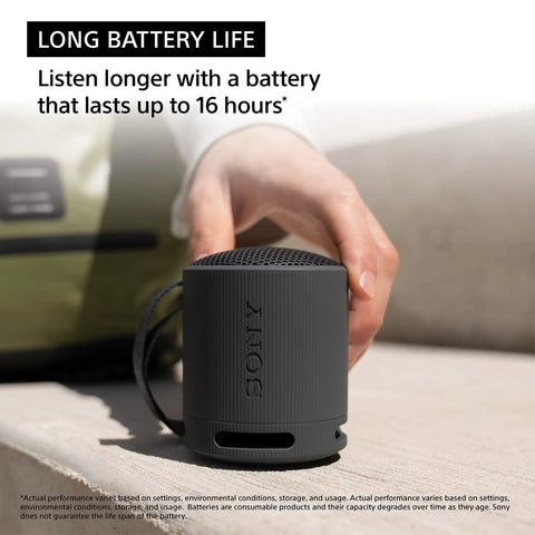 Person holding black XB100 Wireless Bluetooth Portable Speaker With Deep Bass IP67 Waterproof Dustproof Super Compact Travel Buddy 16 Hour Battery Life Versatile Strap Hands Free Calling Black