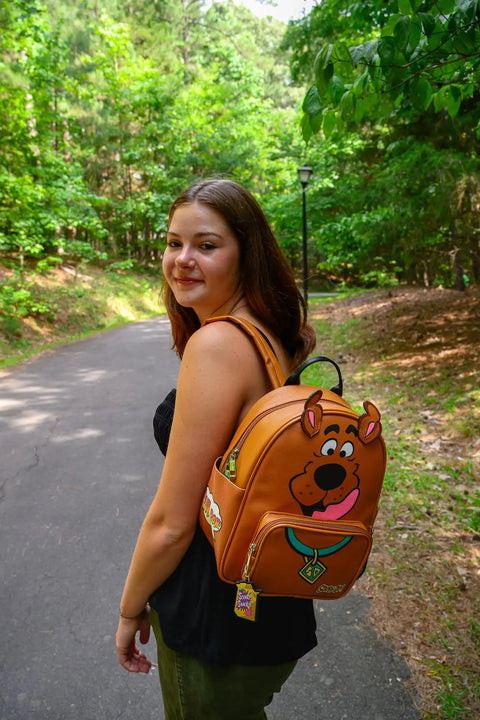 Snag This Totally Rad Scooby Doo Big Face Mini Backpack Purse Crafted From Premium Faux Leather shown on model outdoors.