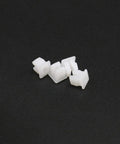 Close-up of five Twenty Pack White Plastic Vehicle Screw Grommets Expandable Insert Nuts on black background.