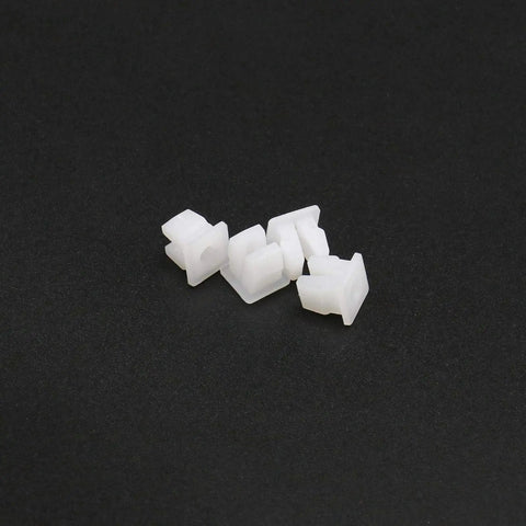 Close-up of five Twenty Pack White Plastic Vehicle Screw Grommets Expandable Insert Nuts on black background.