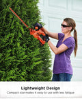 Woman using 20V Max Hedge Trimmer Kit with 18-Inch Blade and dual-action hardened steel blades for quick yard cleanup