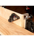 Kickass Flex Stock Guide For Portable Table Saw Featuring Slick Rollers and Fast Height Setup positioned on wood for precise cuts.