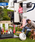 Outdoor BBQ setup with Grill Caddy With Dual Paper Towel Holders, utensils, and condiments next to RV, seating area, and grill.