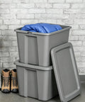 Straight Up Tough As Nails Heavy Duty Plastic Storage Bin With Secure Snap On Lid For Real Garage Setup Or Home Decluttering Projects Gray 18 Gallon Capacity stacked with blue blanket and lined boots.