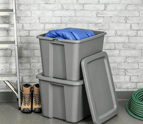 Straight Up Tough As Nails Heavy Duty Plastic Storage Bin With Secure Snap On Lid For Real Garage Setup Or Home Decluttering Projects Gray 18 Gallon Capacity stacked with blue blanket and lined boots.