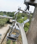 Rugged Heavy Duty Cable Pulley Cast Aluminum Wheel Wear Resistant Sheave attached to tree, guiding cable in outdoor setting