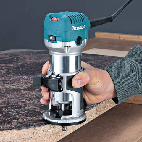 Beefy One And One Quarter Horsepower Compact Router Kit With Variable Speed From 10000 To 30000 RPM Rack And Pinion Fine Depth Adjustment Slim Ergonomic Body And Quick Release Cam Lock For Precise Comfortable Woodworking in use on wooden surface