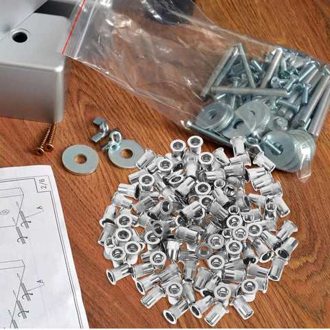 Top Grade 30 Pcs Flat Head Stainless Steel Rivet Nuts Inserts With Knurled Body For Secure Grip and High Vibration Applications laid out on a wooden table.