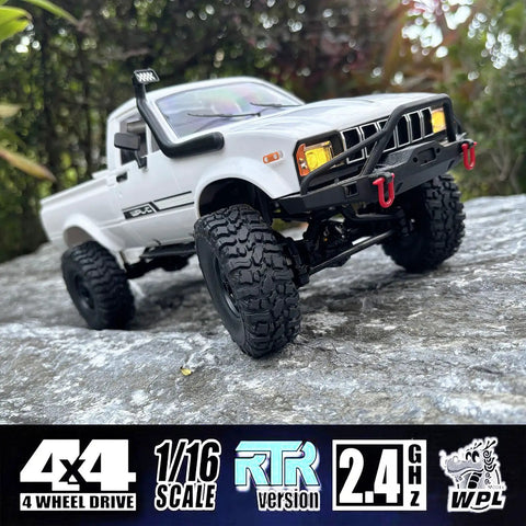 Rugged One Sixteenth Scale RC Rock Crawler Truck 4x4 with realistic interior and LED lights on rocky terrain, ready to run