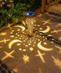 Moon Star Solar Garden Stake Lights Outdoor Waterproof Copper Finish casting crescent and star patterns on a patio at night