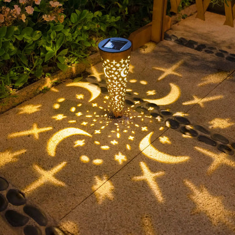 Moon Star Solar Garden Stake Lights Outdoor Waterproof Copper Finish casting crescent and star patterns on a patio at night