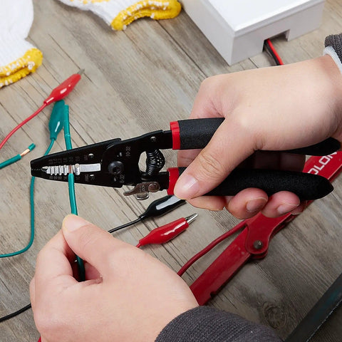 Person using 7 Inch Pro Grade Wire Stripper And Cutter For 10-20 AWG Solid And 0.8-2.6mm Stranded Wire on green wire