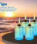 Four Pack Blue Glass Garden Torches 12 Oz Citronella Outdoor Lights on table with sunset view