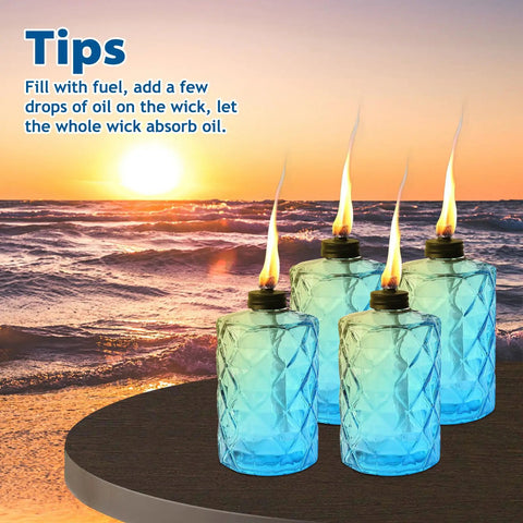 Four Pack Blue Glass Garden Torches 12 Oz Citronella Outdoor Lights on table with sunset view