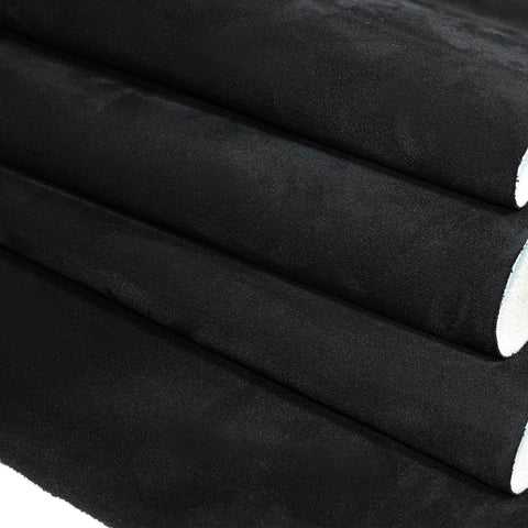 Side view of four black suede headliner fabric rolls with foam backing (96×60 in)