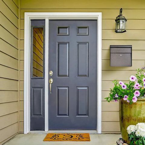 Front entrance with 7164 Metro Bronze High Capacity Wall Mounted Locking Mailbox With Anti Pry Latch And 12 Wafer Disc Lock on wall.