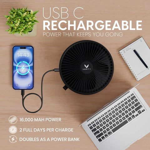 All In One Portable Battery Powered Fan For Travel And Camping with USB C cable and smartphone next to laptop on table
