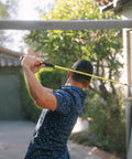 Golfer using ButterBlade Training Club For Golfers, Real Time Feedback To Improve Swing Mechanics And Accuracy in backyard setup
