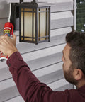 Amazon Flex Caulk 9 oz white sealant being applied to exterior siding near an outdoor lantern