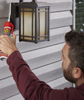 Man using waterproof and weatherproof hybrid polymer caulk for indoor outdoor use paintable sealant that adheres to wet or dry surfaces no caulk gun needed with adjustable flow nozzle clear 6.6 oz 1 pack for baths showers sinks windows doors roofs wood auto on outdoor lantern.