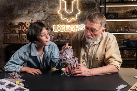 Child and adult assembling Wooden Star Wars AT ST Walker 3D Puzzle Featuring Smooth Shifting Gear System That Delivers Real Walking Motion.