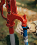 Water Bandit Hose Fitting Repair Tool With Flexible Silicone-Polymer Sleeve And ABS Male Connection in use on outdoor faucet