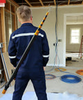 Heavy Duty 19.6ft Telescopic Cable Pulling Pole Made From High Density Carbon Fiber held by professional, ready for wire pushing.