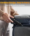 Person placing Mini Cordless Rotary Tool Kit with 5 Speed Settings and USB Charging into backpack, highlighting portability.