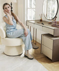 Woman sitting on 360 Degree Swivel Accent Chair in Soft Chenille Boucle Upholstery at vanity, showcasing compact design