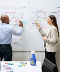 Two professionals using Dry Erase Whiteboard Cleaner Spray 22oz Eliminates Ghosting And Streaks Easy Wipe No Hassle for brainstorming