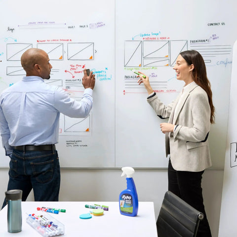Two professionals using Dry Erase Whiteboard Cleaner Spray 22oz Eliminates Ghosting And Streaks Easy Wipe No Hassle for brainstorming